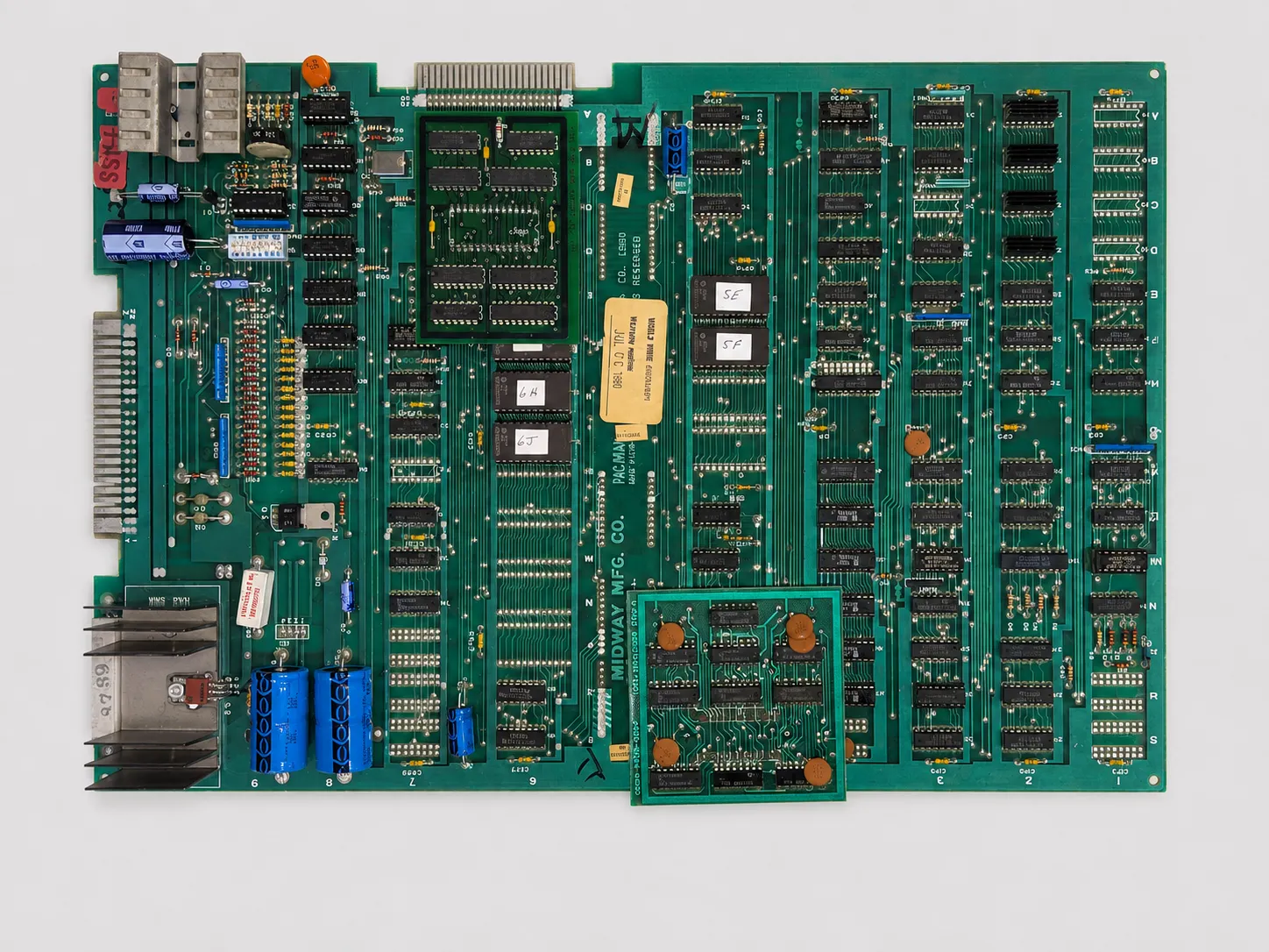 Complete original Midway Pac-Man arcade PCB showing daughterboards, ROM labels, connectors, and board markings